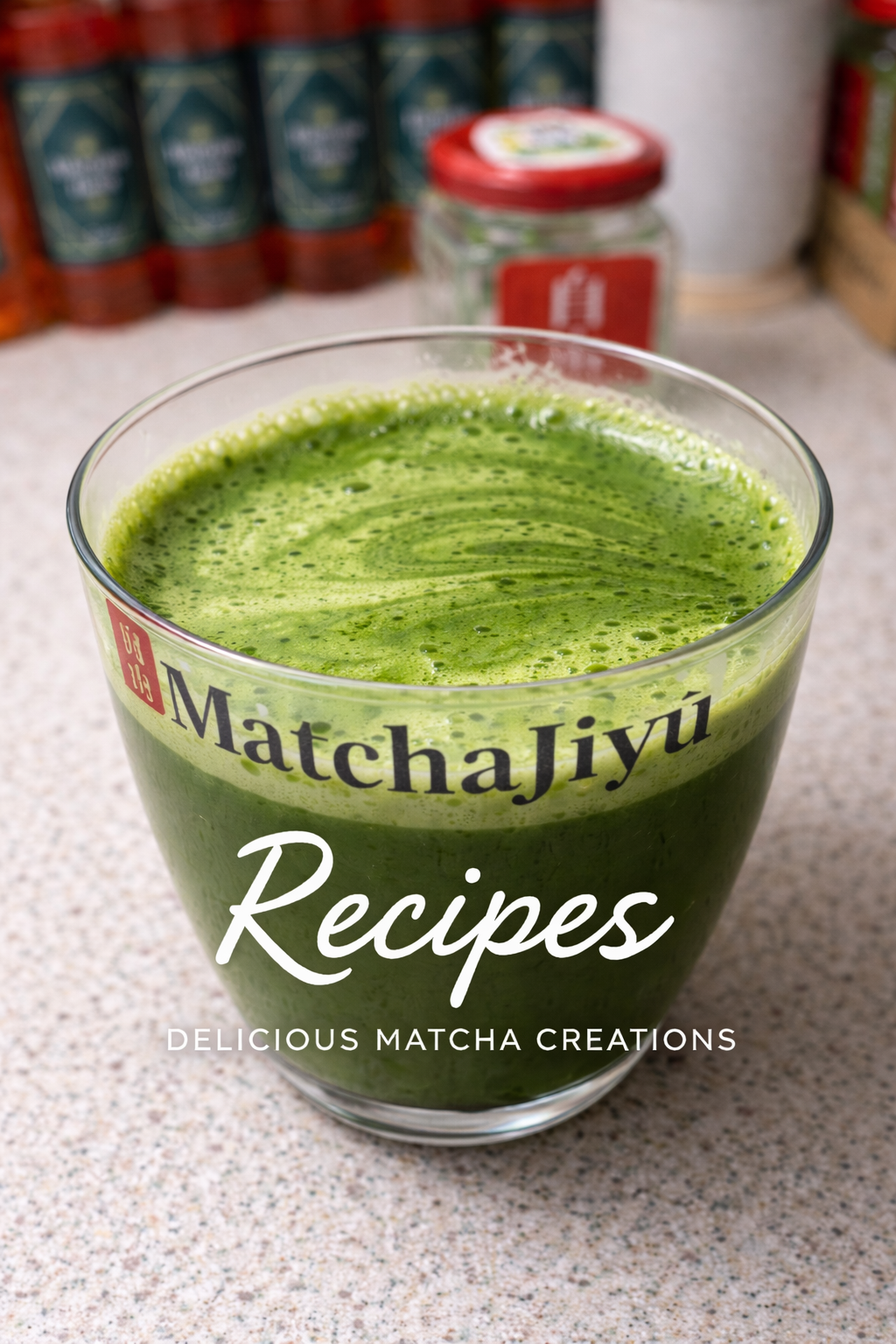 Glass of green matcha drink with 'MatchaJiyé' branding on a countertop. Hot Matcha Latte Recipe