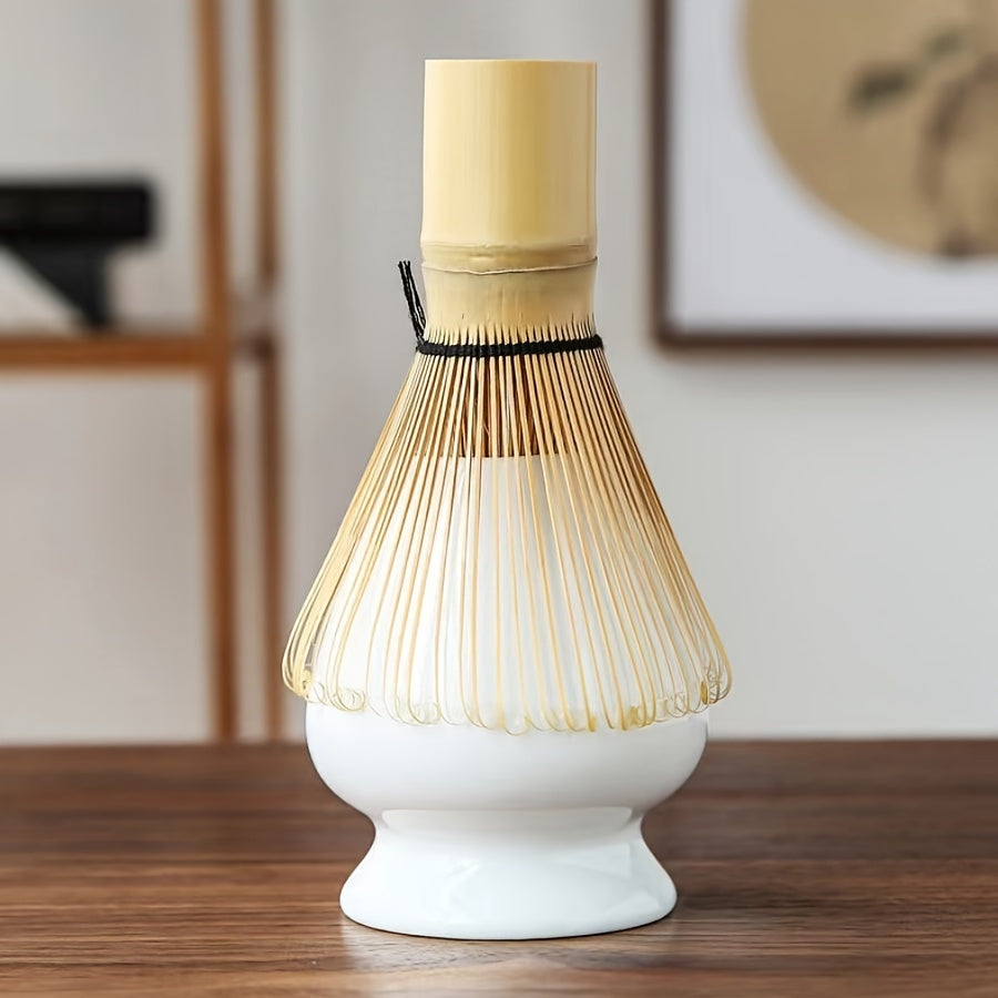 White base with a bamboo whisk on a wooden surface