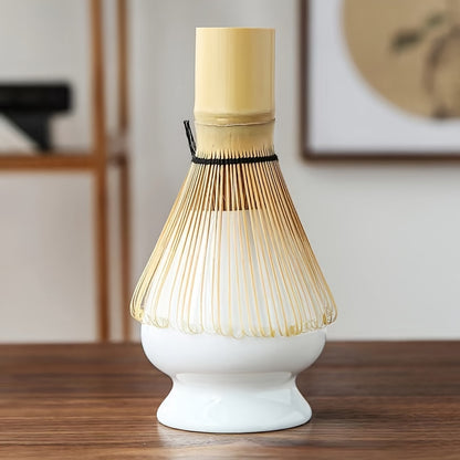 White base with a bamboo whisk on a wooden surface